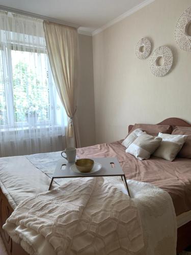 a bedroom with a bed with a tray on it at Центр (2). Простора квартира. С. Крушельницької in Ternopil