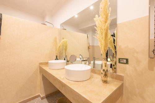 a bathroom with two sinks and a large mirror at Riad Ksar Saad & Spa in Marrakech