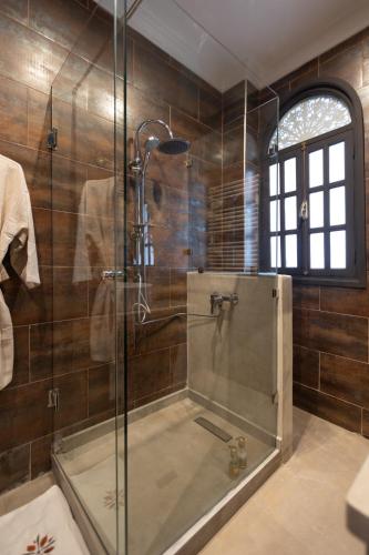 a bathroom with a shower with a glass door at Riad Ksar Saad & Spa in Marrakech