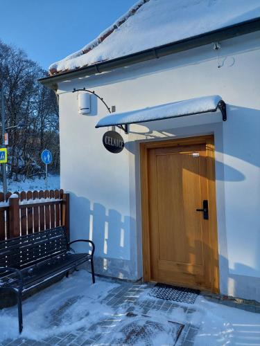a building with a wooden door and a bench at Villa Celnice in Český Krumlov