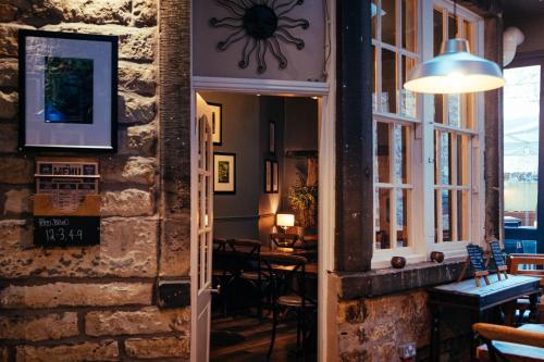 a door leading into a restaurant with tables and chairs at The Sun Hotel & Bar in Lancaster