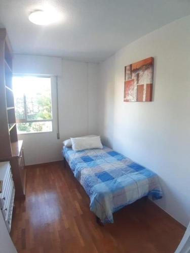 a bedroom with a bed in a room with a window at Plaza PUERTA NUEVA in Murcia