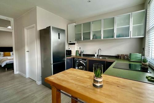 cocina con mesa de madera en una habitación en Sienna's 2 - bedroom apartment, London, N1., en Londres