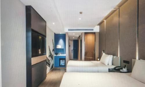 a hotel room with two beds and a television at Atour Hotel Jiading Jiangqiao Jiayi Road Subway Station in Fengbang