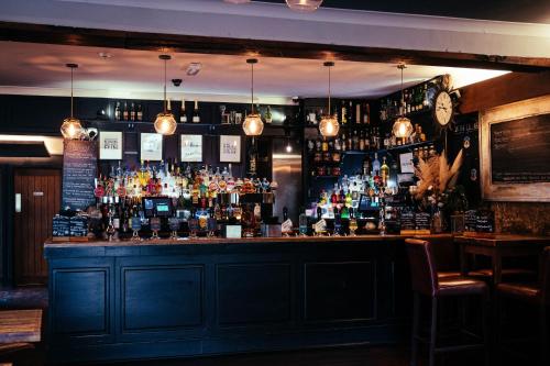 a bar with a lot of bottles of alcohol at The Sun Hotel & Bar in Lancaster