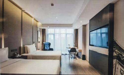 a hotel room with two beds and a flat screen tv at Atour Hotel Jiading Jiangqiao Jiayi Road Subway Station in Fengbang