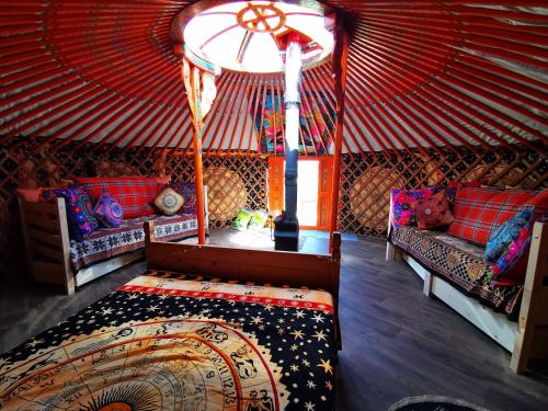 a room with a bed in a yurt at The Yurt in Newton Stewart