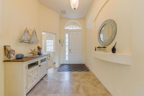 a hallway with a white door and a mirror at Tuscan Pines Villa in Davenport