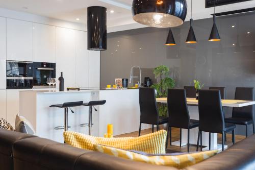 a kitchen and dining room with a table and chairs at InPoint Central Apartments in Kraków