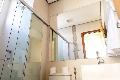a bathroom with a toilet and a mirror at Pousada Sossego da Pampulha in Belo Horizonte