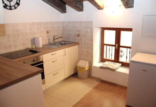 a kitchen with a sink and a window at City Heart Residence in Šibenik