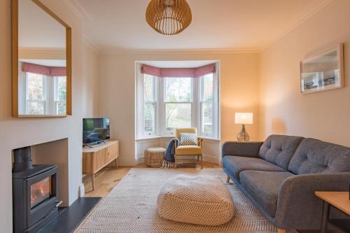 a living room with a couch and a fireplace at Liberty Cottage in Broadstairs