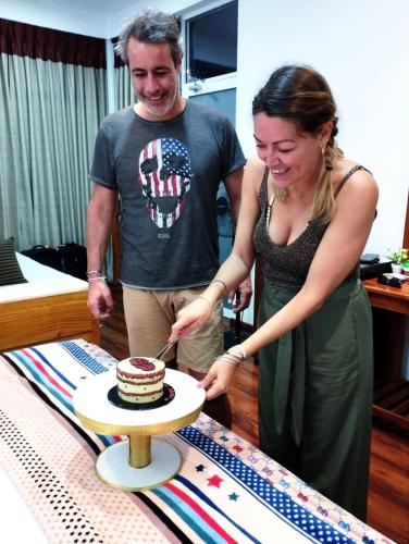 a man and a woman cutting a cake at Poomaz Peace Palace in Ella