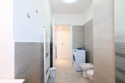 a bathroom with a white toilet and a sink at PrimoPiano - Caduti Missione in Milan