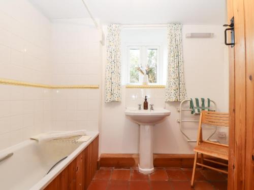 a bathroom with a sink and a tub and a toilet at The Barley Crush in Bodmin