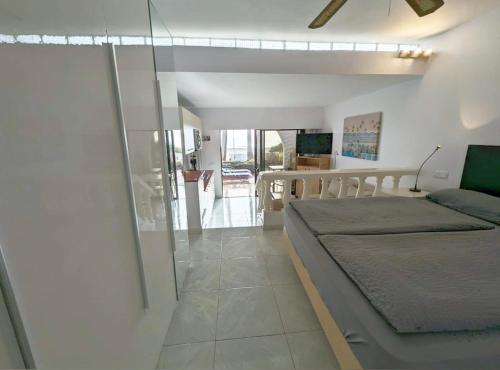 a bedroom with a bed and a glass wall at Beachhouse La Palma in Costa Calma