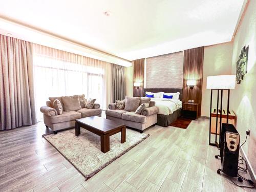 a large living room with a bed and a couch at Virunga Inn Resort & Spa in Kinigi
