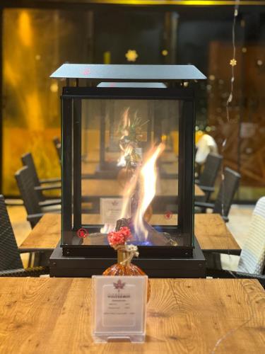 a fire in a vase sitting on a table at Design Hotel Winterrot in Karlsruhe