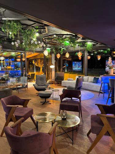 a lobby with couches and chairs and tables at Design Hotel Winterrot in Karlsruhe