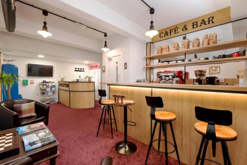 a cafe and bar with stools and a counter at SMITH PLACE HOTEL in Edinburgh