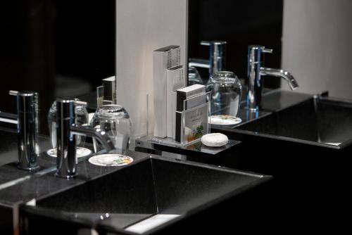 a bathroom counter with two sinks and a mirror at Hospes Palacio del Bailio, a Member of Design Hotels in Córdoba