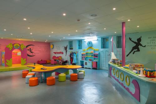 a childrens play room with a table and play equipment at Riviera by Isrotel Collection in Eilat