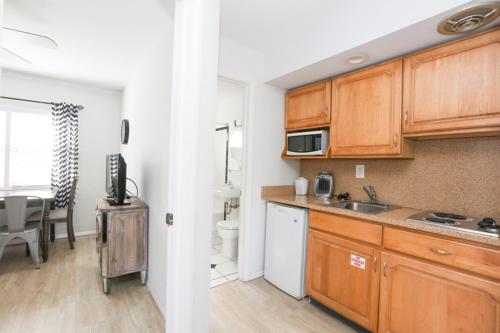 a kitchen with wooden cabinets and a dining room at The Southwinds in Cape May