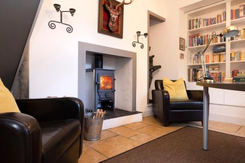 a living room with a wood burning stove at Strathendrick House Magnificent property with Garden in Drymen