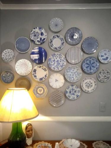 a wall with blue and white plates on a wall at McKinley Hills BGC Taguig City Condo in Manila