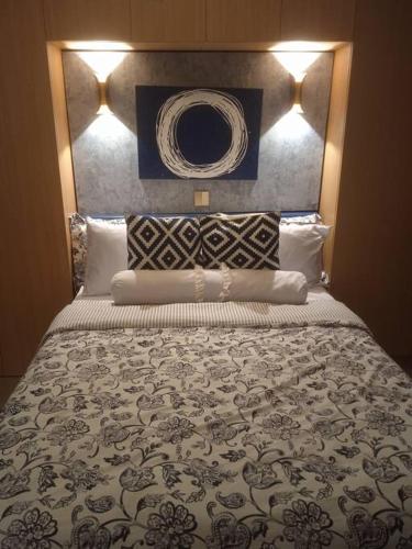 a bedroom with a large bed with a large headboard at McKinley Hills BGC Taguig City Condo in Manila