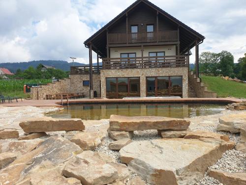 a house with a swimming pool in front of it at Penzion u Pinkasů s wellness in Jablunkov