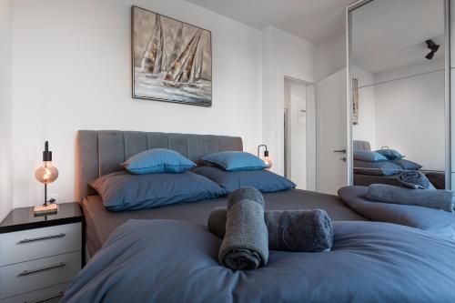 a bedroom with two beds with towels on them at Nautilus Apartment II Whirlpool in Novalja