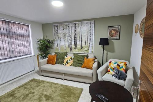 a living room with two couches and a window at Manchester, Rusholme, UK with free parking in Manchester