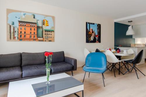 un salon avec un canapé et une table dans l'établissement Casteja Modern Residence, à Boulogne-Billancourt