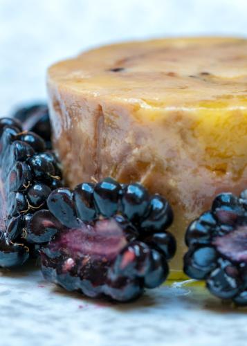 a piece of cake with blackberries next to it at Ballymascanlon Hotel and Golf Resort in Dundalk
