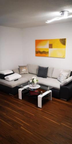a living room with a couch and a coffee table at Haus am Fuße des Semmerings in Schottwien