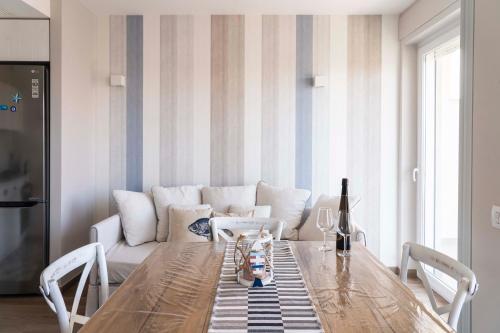 a living room with a couch and a wooden table at San Vito Luxury Accomodation in Polignano a Mare