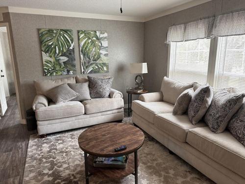 a living room with two couches and a table at Sweet retreat in the springs NOT waterfront property in Homosassa