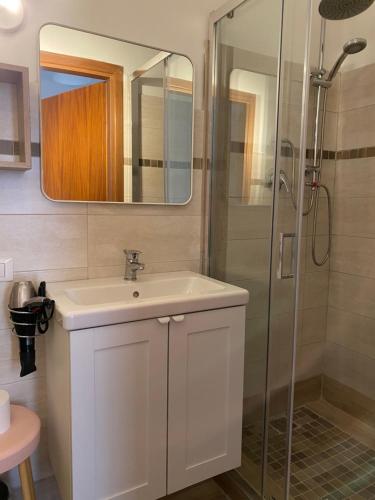 a bathroom with a white sink and a shower at Paste&cannola in Lampedusa