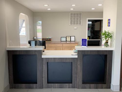a lobby with two large counters in a building at Days Inn by Wyndham Wagoner in Wagoner