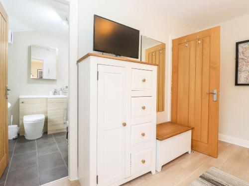 a bathroom with a white cabinet with a tv on top at Timley Knott in Coniston