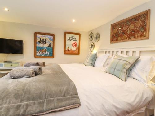 a bedroom with a large white bed and a flat screen tv at Timley Knott in Coniston