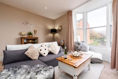 a living room with a couch and a table at The Cosy Norse Retreat in York