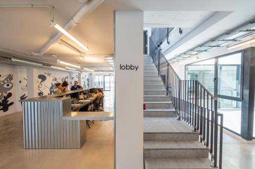 a stairway leading up to the lobby of a office building at Micampus Alicante Student Residence in San Vicente del Raspeig
