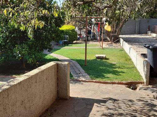 a park with a playground with a swing at Furnished self catering cottage in Lusaka
