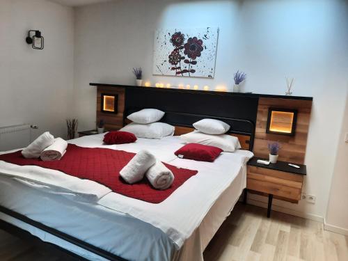 a bedroom with a large bed with red and white pillows at Exclusive Art Apartment in Krakow