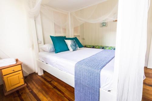 A bed or beds in a room at Castara Cottage by Hello Mello