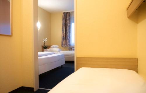 Ένα ή περισσότερα κρεβάτια σε δωμάτιο στο Friends Hotel Kerpen