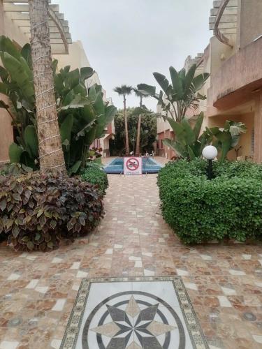 a walkway leading to a building with a sign on it at HILAL in Sidi Bouzid