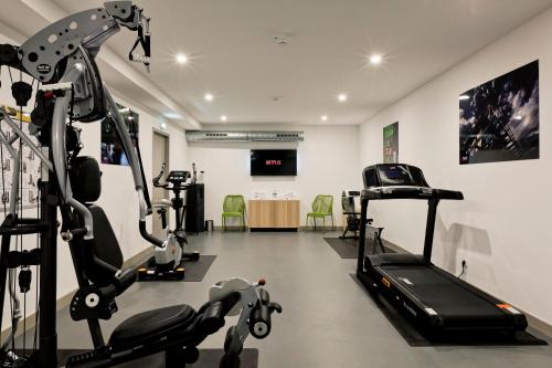 a gym with two tread machines and a treadmill at Best Western Crequi Lyon Part Dieu in Lyon